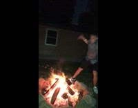 guy picks up log on fire bash on head