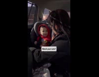 Grandmother laughs while she removes grandson seatbelt