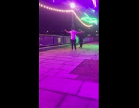 Man white shirt walk rap purple lights