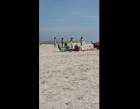 Four girls in line jump dance beach