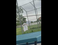 Woman ghost outfit swing baseball bat yard