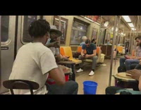 3 guys play drums in train 
