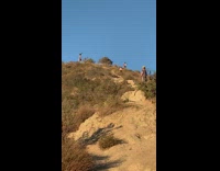 Man orange top hand stand Canyon Top