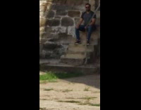 Guy sits poses stairs pink shirt ot. 2