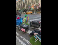 People on engineered lawn chairs riding on street