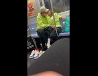 Couple in bright green sweaters making out