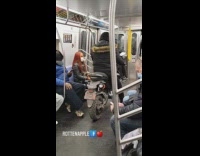 Guy sitting on motorbike in middle of subway train