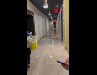Rain water floods hallway of apartment building