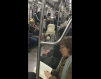older man in hate does hand stand on train