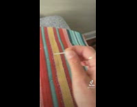 Girl sets up seat trap for person smoking on porch