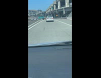 Drunk driver drives white car off freeway exit and crashes into metal rail