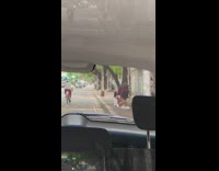 Black shorts girl sits sidewalk face shield 