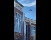 Drone pressure wash wall with soapy water