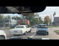 White low rider car bounces at stoplight