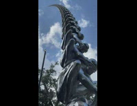 Men squat in sculpture 