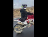 Guy falls off dirt bike doing a wheelie 
