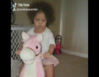 Girl rides on pink toy horse and dances to Old Town Road billy ray cyrus