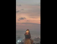 Woman selfie video with flash beside pool