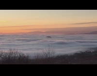 Clouds in a valley moving in wave like motion