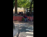 Man washing face on broken fire hydrant