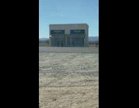 Woman grey coat prada store road sunny