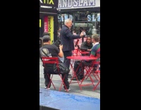 Man demonstrating hypnosis with man on street