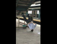 Guy black helmet headstand legs against railing 