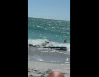 Woman records her boyfriend at beach being childish