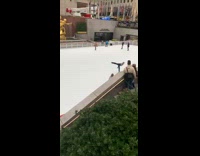 Bald man ice skating one leg flaps arms