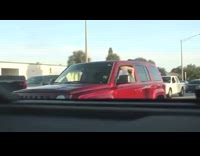 Guy throws cheese slice at red car 