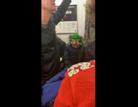 Guy wears Luigi beanie on subway train