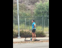 Man talks for run video on sidewalk