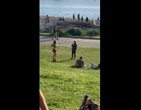 Girl black crop top crowded shore park
