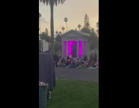 Woman poses in front of lights at cemetery 