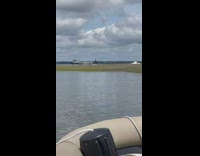 Submarine gets escorted out of bay 