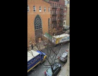 White truck rips green awning off building