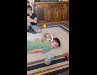 Dog licks boy face lies on floor
