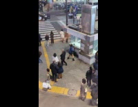 Woman blue stripes top dances subway stairs