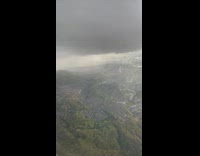 Large grey cloud outside plane window 