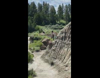 Two women wave hands tiktok dance by the rock