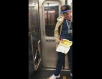 Man eats food in to go box and spills on floor, man on left makes disgusted face