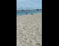 Man exercise beside two women beach photoshoot