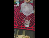 Girl pours water from pitcher and drinks