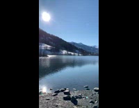 guy looks out at lake and mountains 