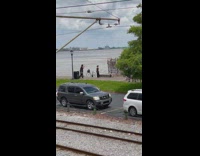 Woman wears black dress arms fly river