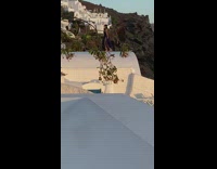 Woman black dress run roof sunset santorini