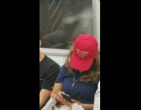 Woman wears red MAGA weed hat make america legalize again on subway train