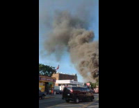 Black smoke comes out from burning tire shop