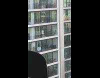 Woman white oversize polo tiktok dance building