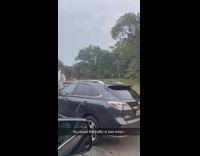 Cars avoiding traffic on side of road drive into forest 